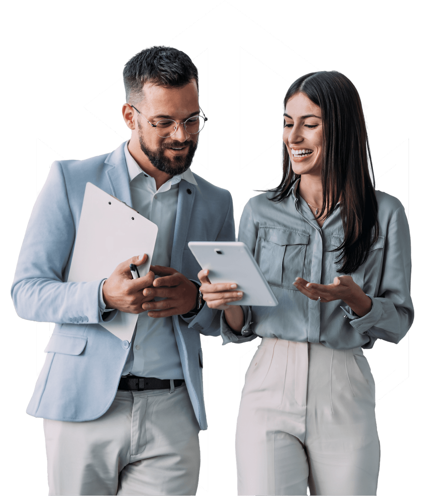 A man and a woman in business attire discuss something on a tablet, both smiling and holding folders.